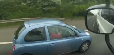 Woman applying make-up while driving