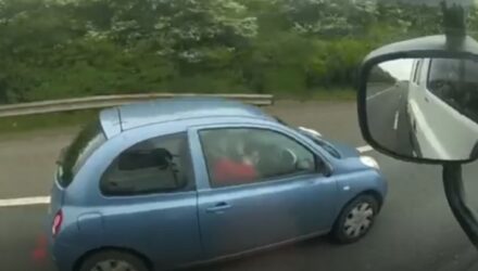 Woman applying make-up while driving