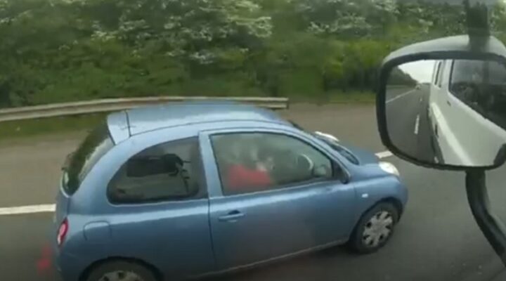 Woman applying make-up while driving