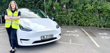XPO employee with her new electric car