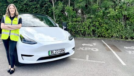 XPO employee with her new electric car
