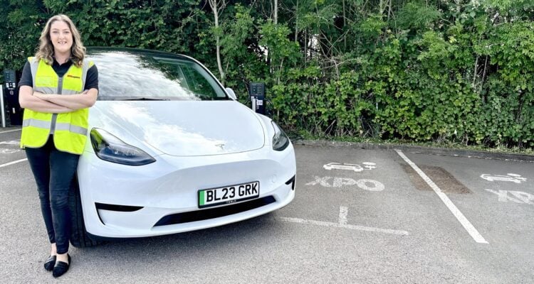 XPO employee with her new electric car