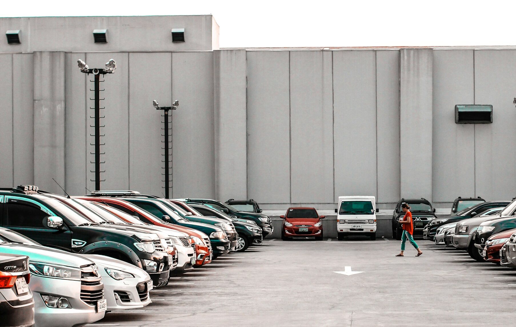 Person walking towards a parked car