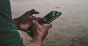 Someone using a mobile phone outdoors