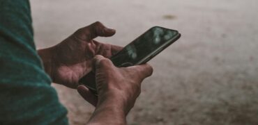 Someone using a mobile phone outdoors