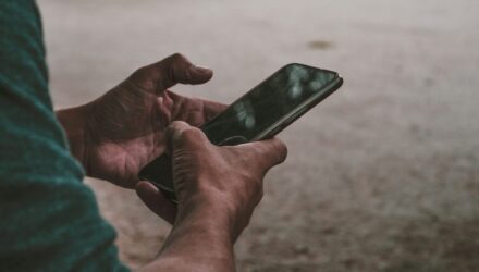 Someone using a mobile phone outdoors