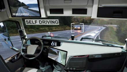 Self driving truck with head up display on a road. Inside view.