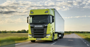 Yellow Scania truck on the road