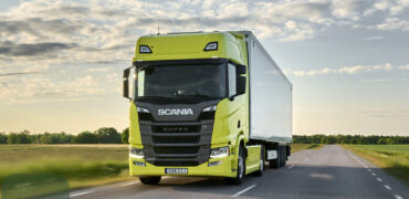 Yellow Scania truck on the road