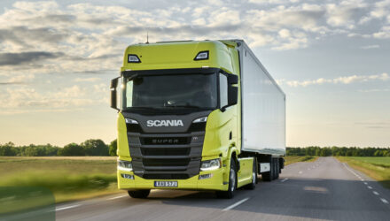 Yellow Scania truck on the road