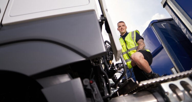 HGV driver checking his vehicle