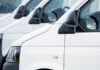 A row of white electric vans