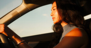 Woman driving in sunlight