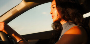 Woman driving in sunlight