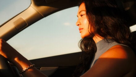 Woman driving in sunlight