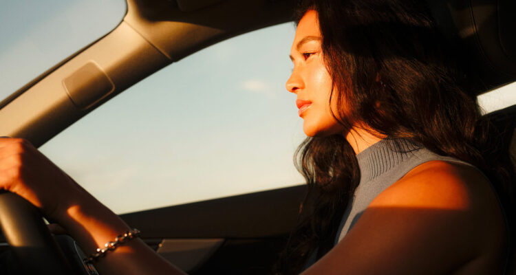 Woman driving in sunlight