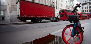 London street scene with bike lorry and buses