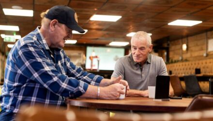 Two HGV drivers chatting over a mug of tea