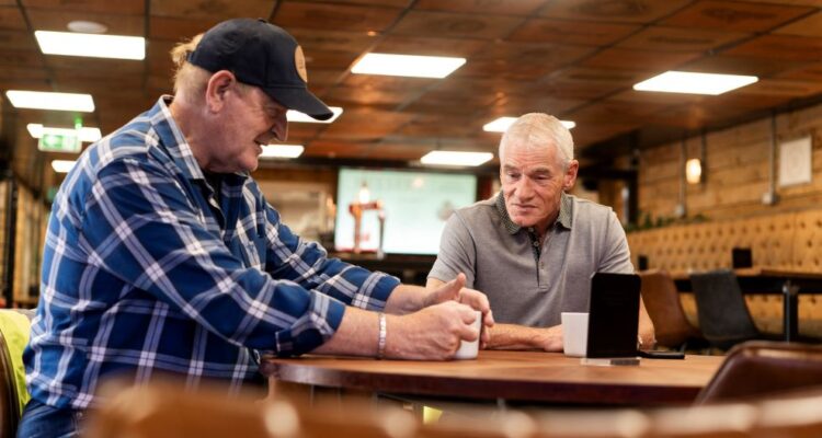 Two HGV drivers chatting over a mug of tea