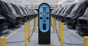 Modern electric EV delivery vans are being charged in company parking garage