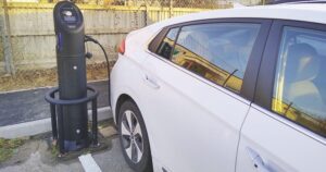 White electric car at a charging station