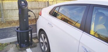 White electric car at a charging station