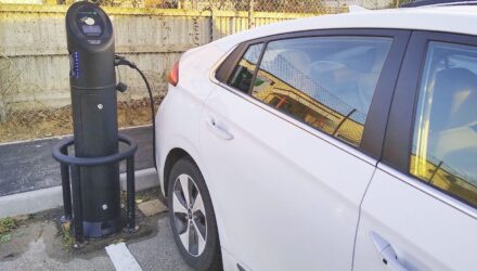 White electric car at a charging station