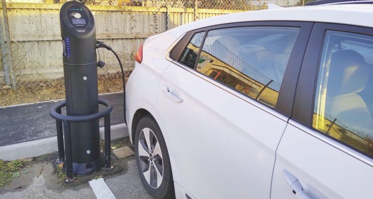 White electric car at a charging station