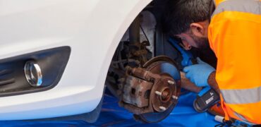 RAC mechanic checking brakes on a car