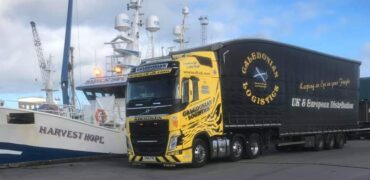 Caledonian Logistics alongside a ship in the harbour