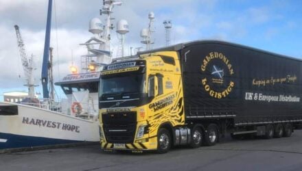 Caledonian Logistics alongside a ship in the harbour