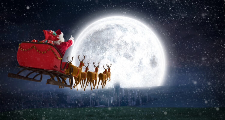 Santa in his sleigh flying towards a very bright full moon