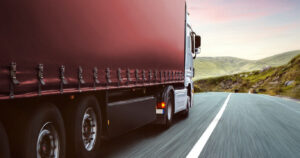 Side view of a red curtainsider lorry