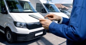 Manager with a digital tablet in the background of Vans.