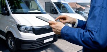 Manager with a digital tablet in the background of Vans.
