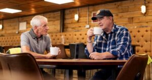 Two truck drivers having a cup of coffee at a truck stop