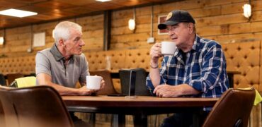 Two truck drivers having a cup of coffee at a truck stop