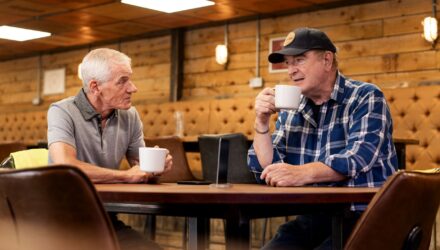 Two truck drivers having a cup of coffee at a truck stop