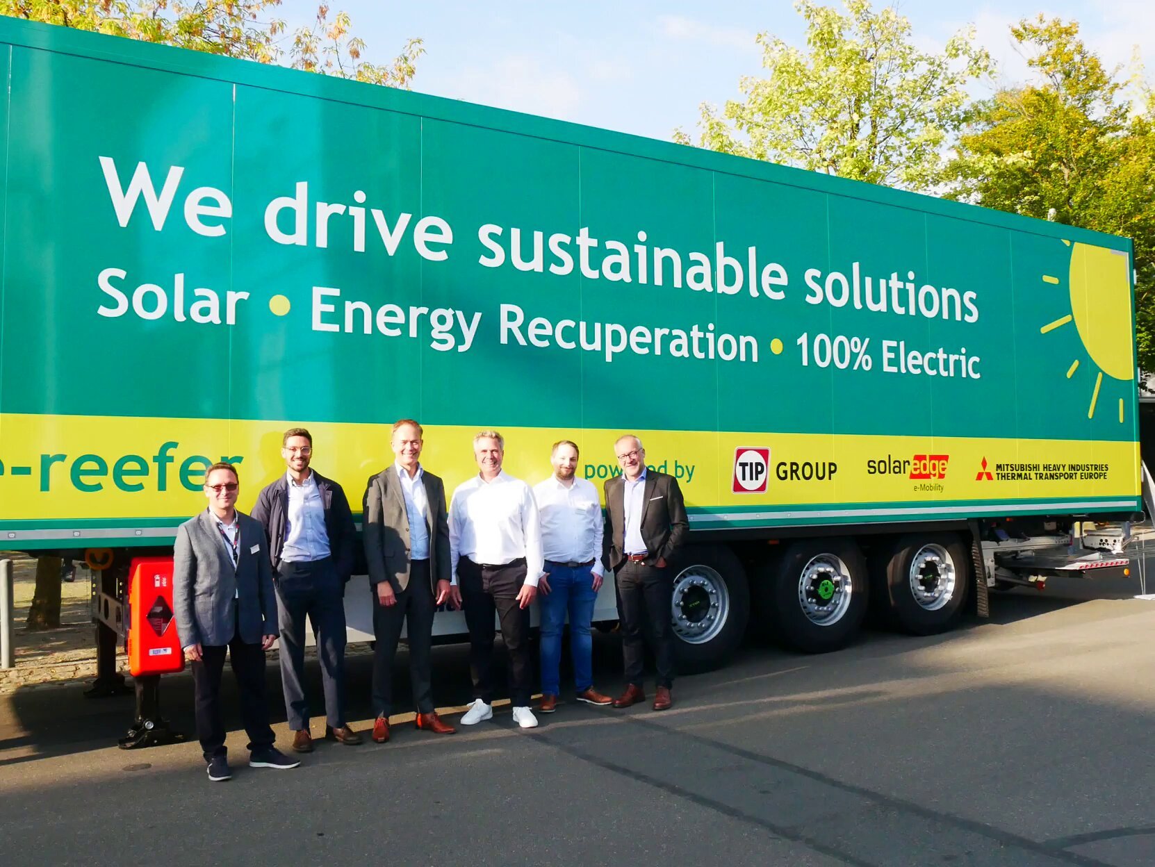 The SolarEdge e-Mobility, TIP Group and Mitsubishi Heavy Industries Thermal Transport Europe GmbH teams in front of the Powered Trailer at IAA Transportation